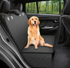 Golden retriever sitting on a black pet car seat cover, showcasing a comfy ride for pets.
