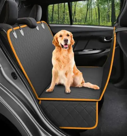 Golden retriever sitting on a premium pet seat cover in a car, providing comfort and protection.